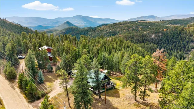 a view of a house with a yard and sitting area