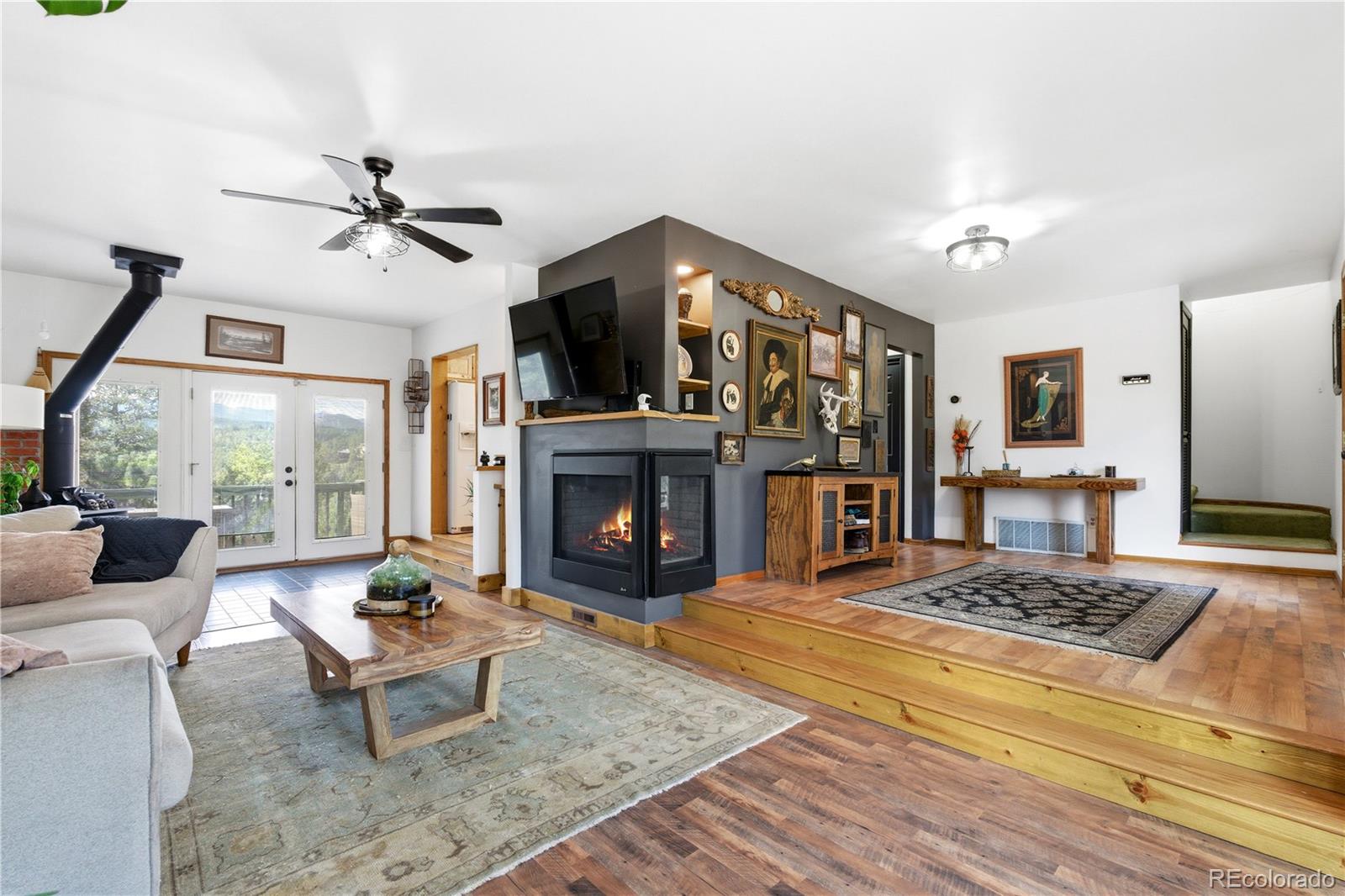 243 Hi Meadow Drive Bailey, CO 80421 - Photo 6 of 37 a living room with furniture a fireplace and a flat screen tv