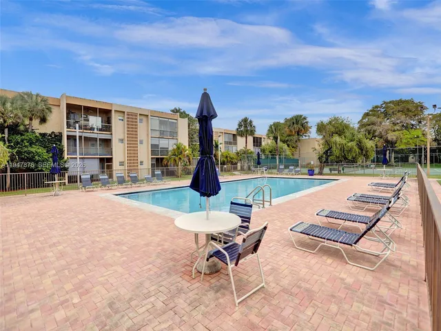 a swimming pool with outdoor seating and yard