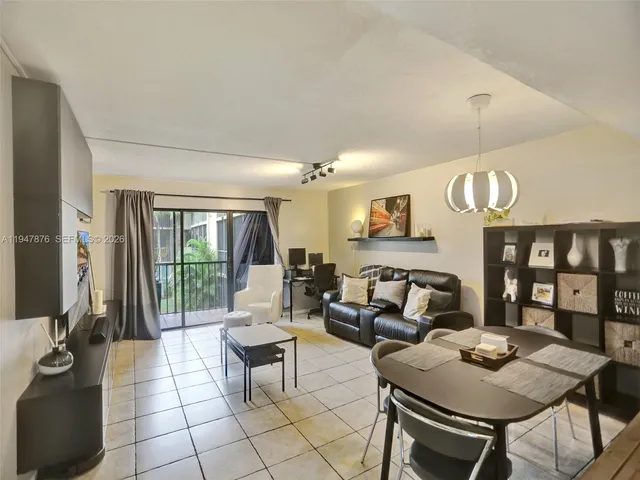 a living room with fireplace furniture and a floor to ceiling window
