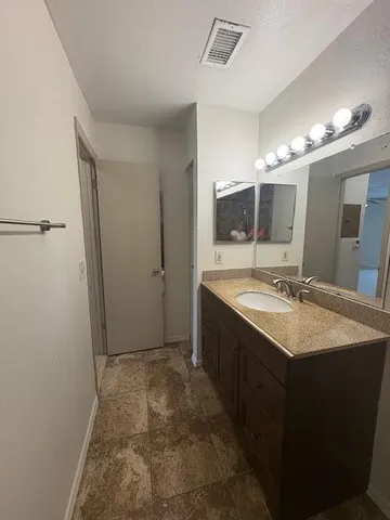 a bathroom with a sink double vanity and a mirror