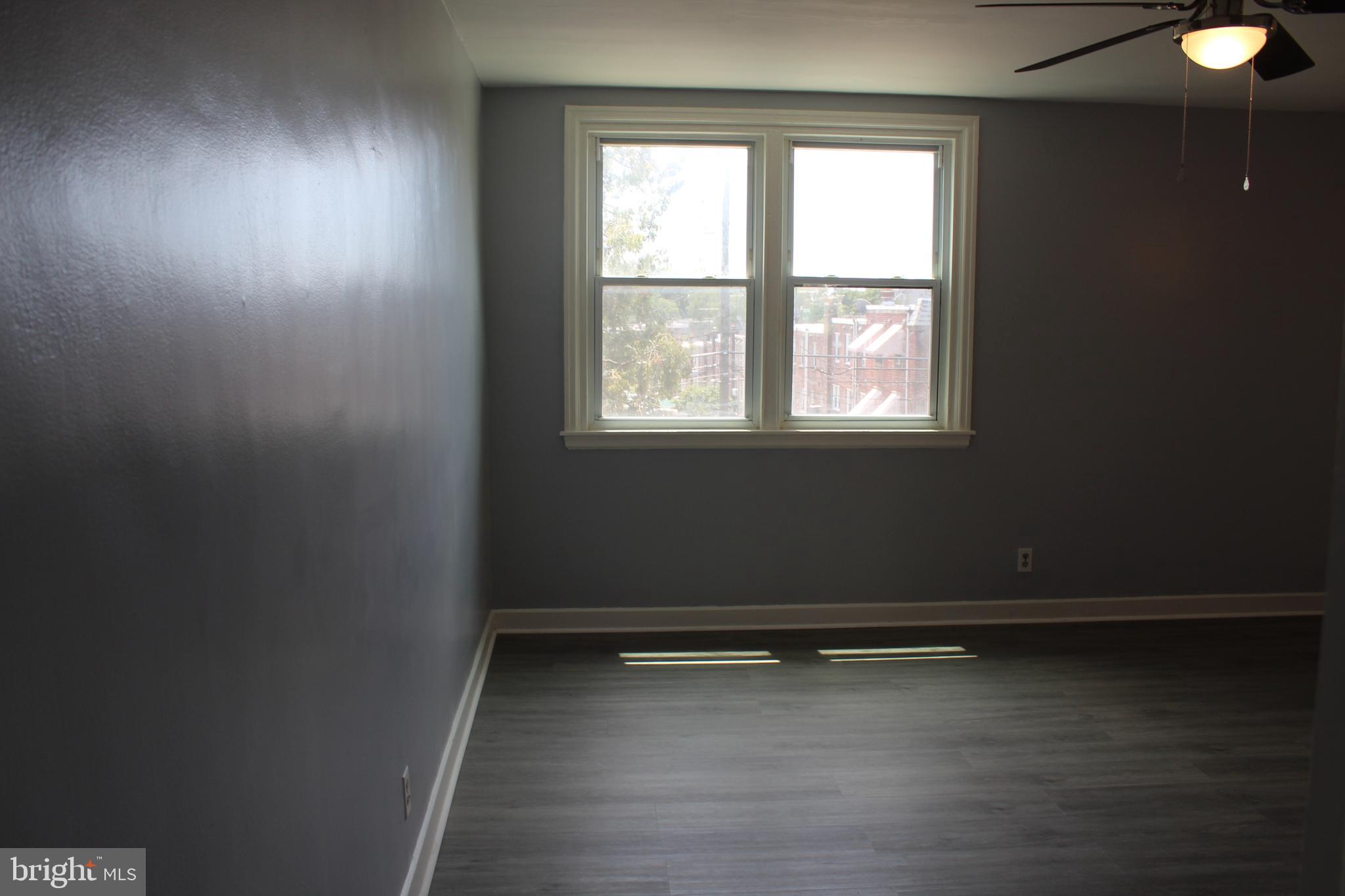 565 East Tabor Road Philadelphia, PA 19120 - Photo 12 of 20 an empty room with wooden floor and windows