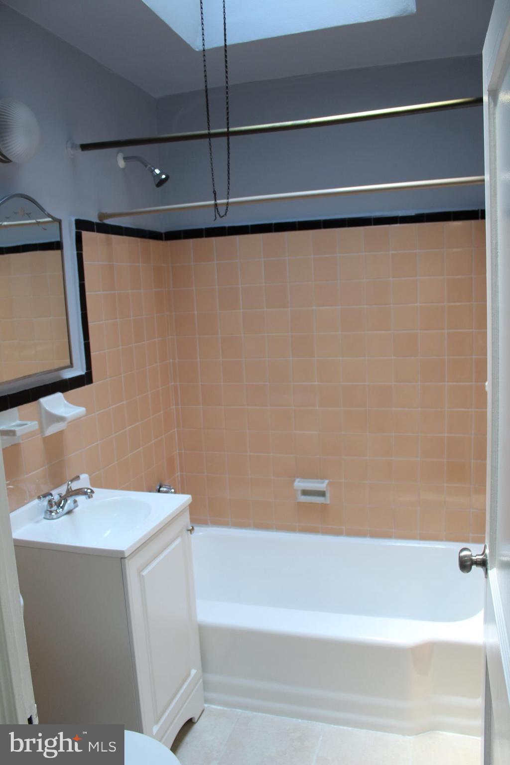 565 East Tabor Road Philadelphia, PA 19120 - Photo 15 of 20 a bathroom with a bathtub and a sink