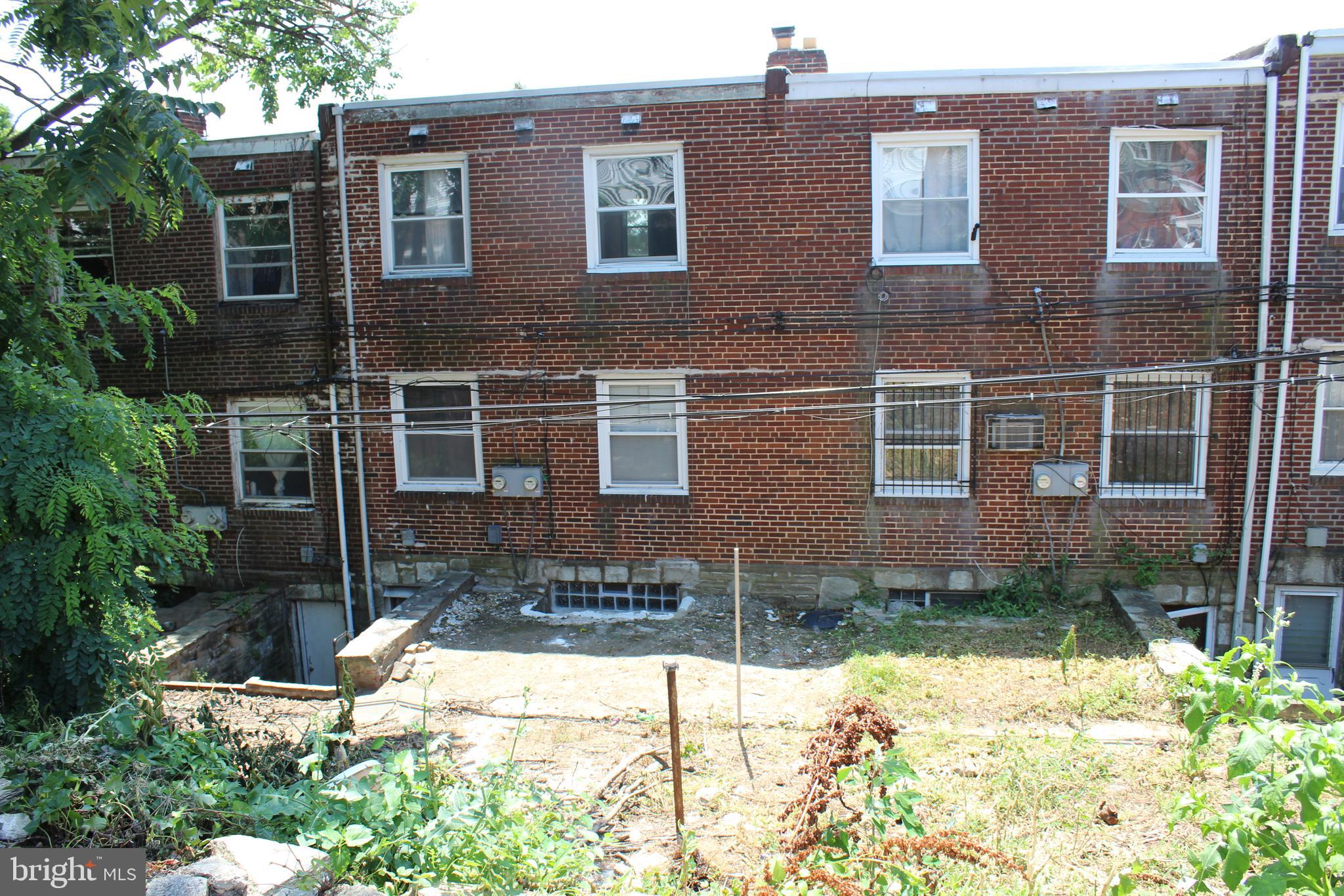 565 East Tabor Road Philadelphia, PA 19120 - Photo 2 of 20 a view of a brick house with windows and yard