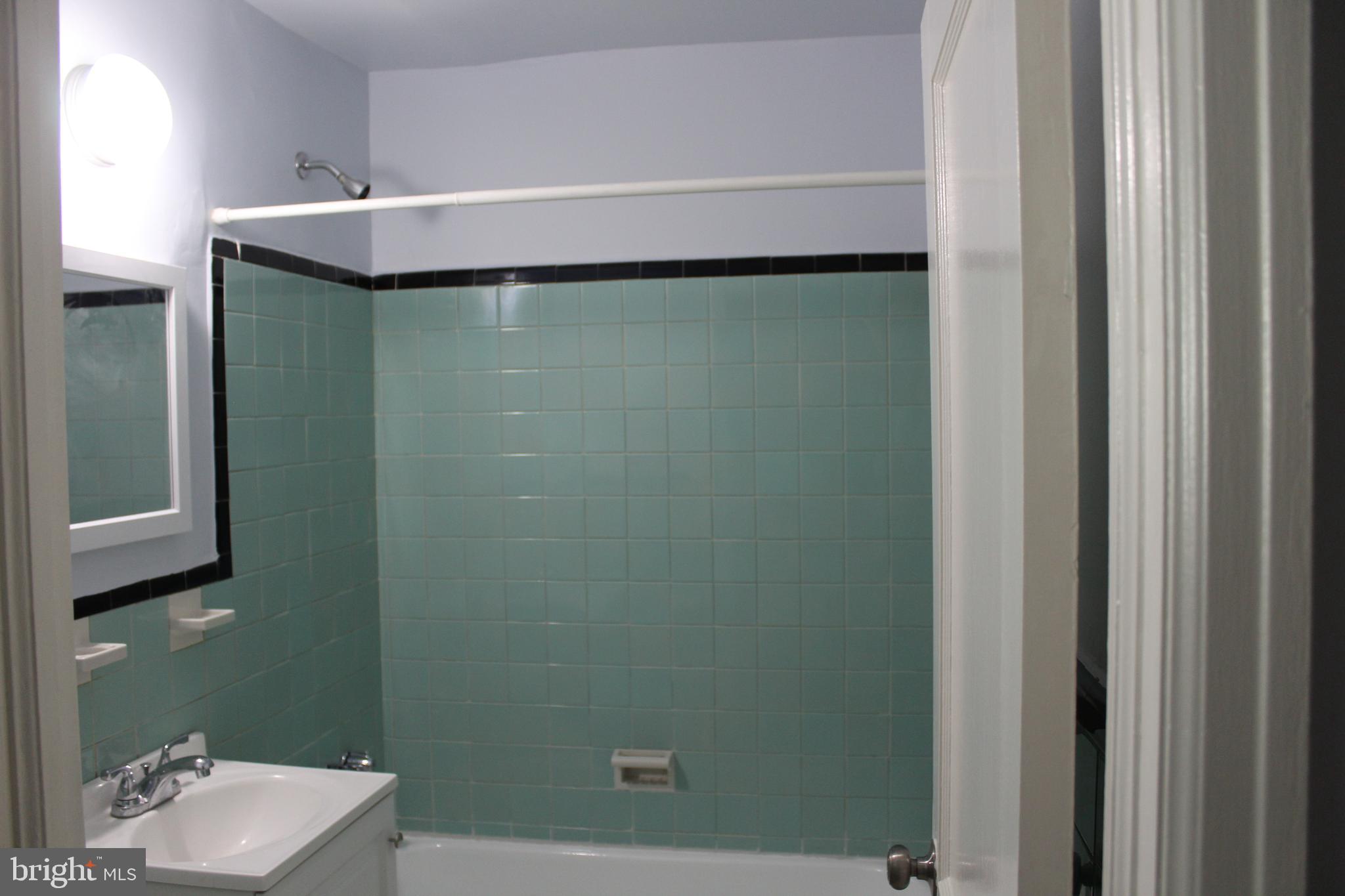 565 East Tabor Road Philadelphia, PA 19120 - Photo 7 of 20 a bathroom with a sink and mirror