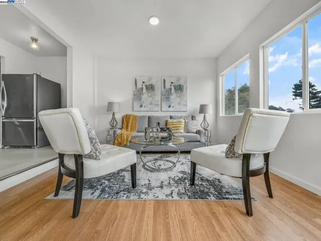 a spacious bedroom with a bed and chair