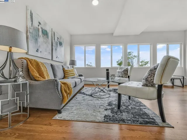 a bedroom with a bed and painting on the wall