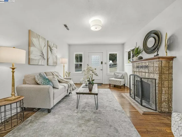 a living room with furniture and a fireplace