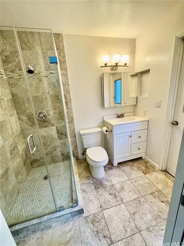 a bathroom with a double vanity sink toilet mirror and shower