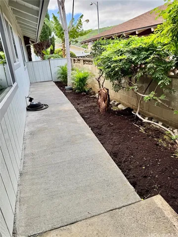 a view of a backyard with potted plants