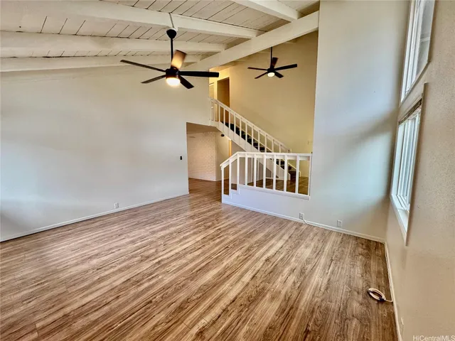 a view of a room with wooden floor and stairs