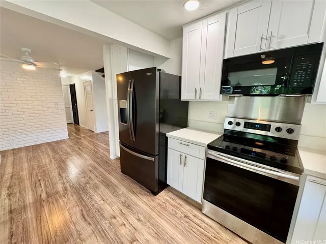 a kitchen with wooden cabinets and stainless steel appliances