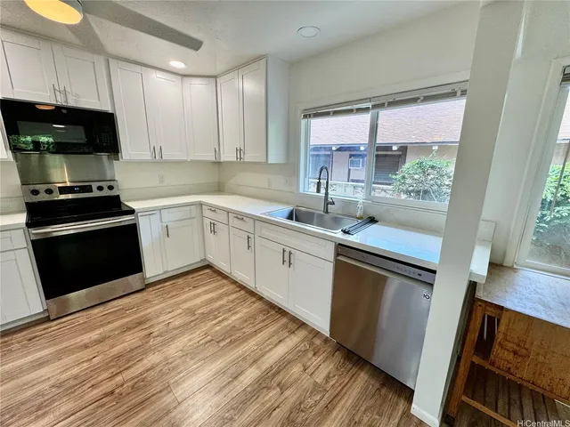 a kitchen with a sink stove and cabinets