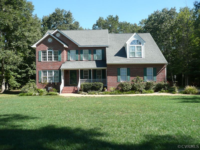 a front view of a house with a yard table and chairs