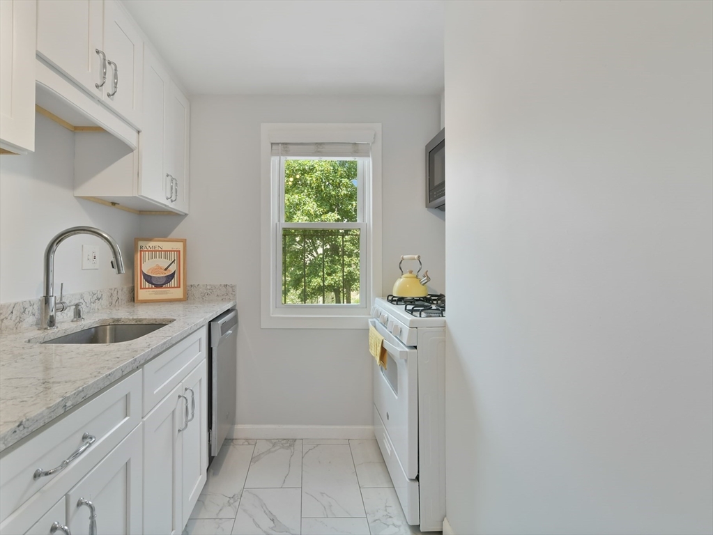 23 Newman Road, Unit 3 Malden, MA 02148 - Photo 3 of 11 a kitchen with a sink a stove and cabinets