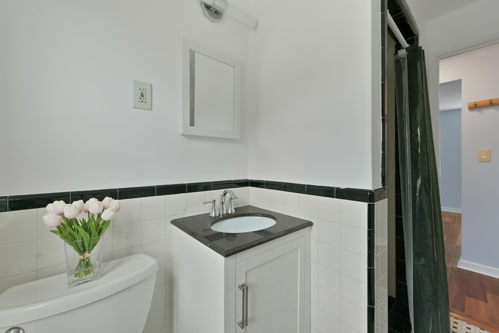 23 Newman Road, Unit 3 Malden, MA 02148 - Photo 8 of 11 a bathroom with a sink and a mirror