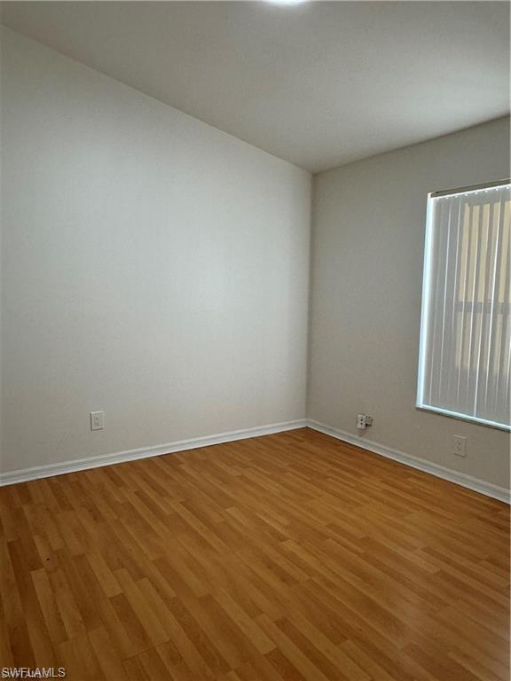 21565 Windham Run Estero, FL 33928 - Photo 13 of 23 a view of an empty room with wooden floor and a window