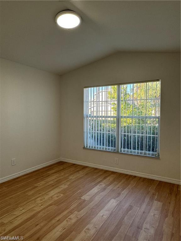 21565 Windham Run Estero, FL 33928 - Photo 15 of 23 a view of an empty room with wooden floor and a window