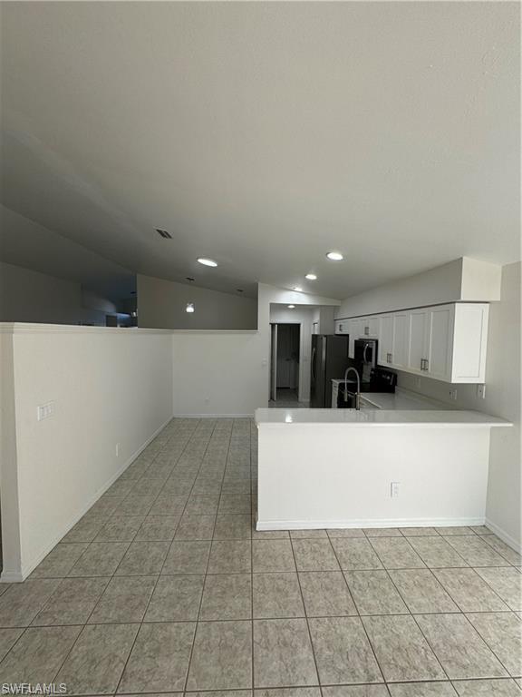 21565 Windham Run Estero, FL 33928 - Photo 4 of 23 a view of a kitchen with a sink and a refrigerator