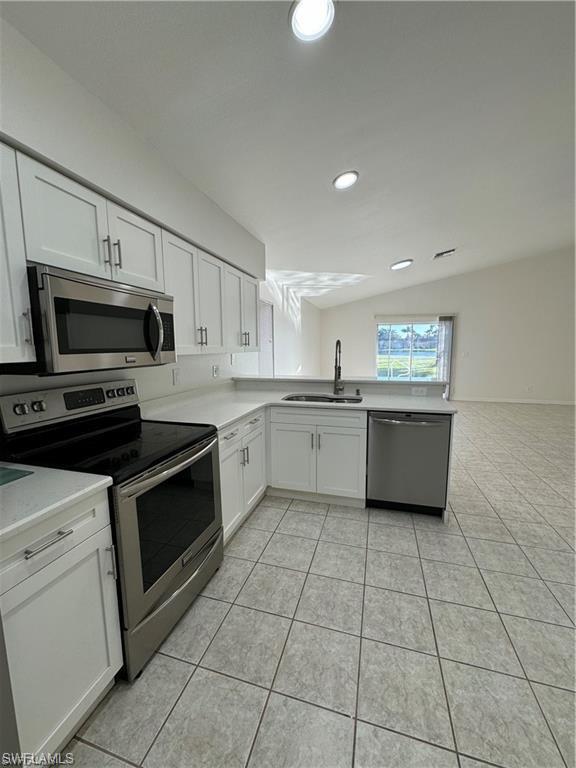 21565 Windham Run Estero, FL 33928 - Photo 5 of 23 a kitchen with a stove a sink and a microwave