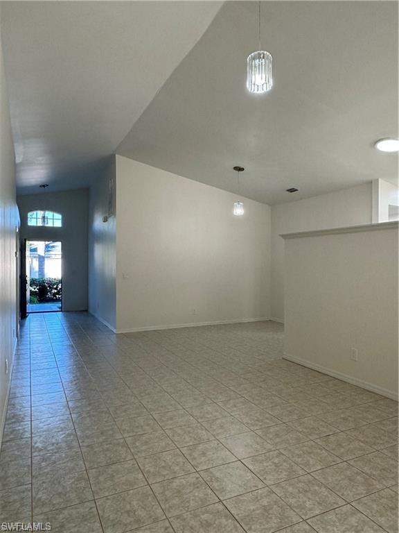 21565 Windham Run Estero, FL 33928 - Photo 6 of 23 an empty room with wooden floor and windows