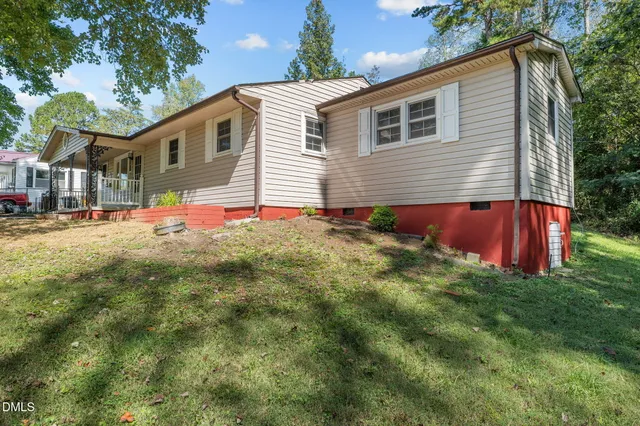 a view of backyard of house with green space