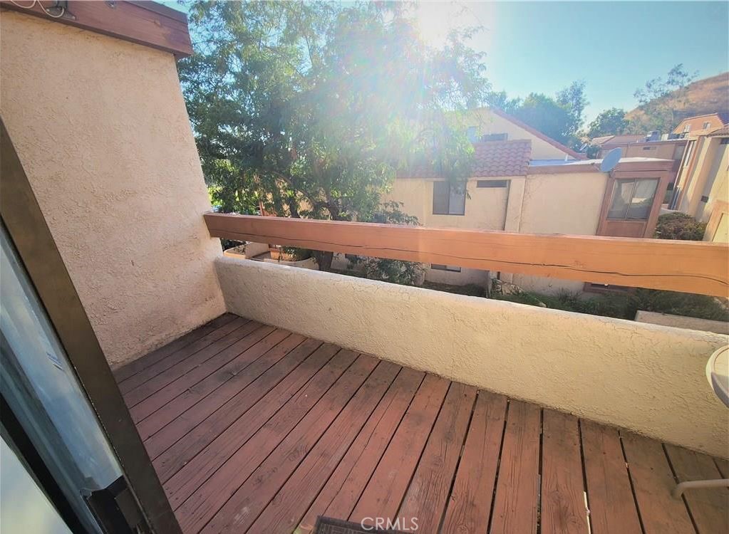 1440 West Edgehill Road, Unit 14 San Bernardino, CA 92405 - Photo 9 of 34 a view of balcony with wooden floor and fence