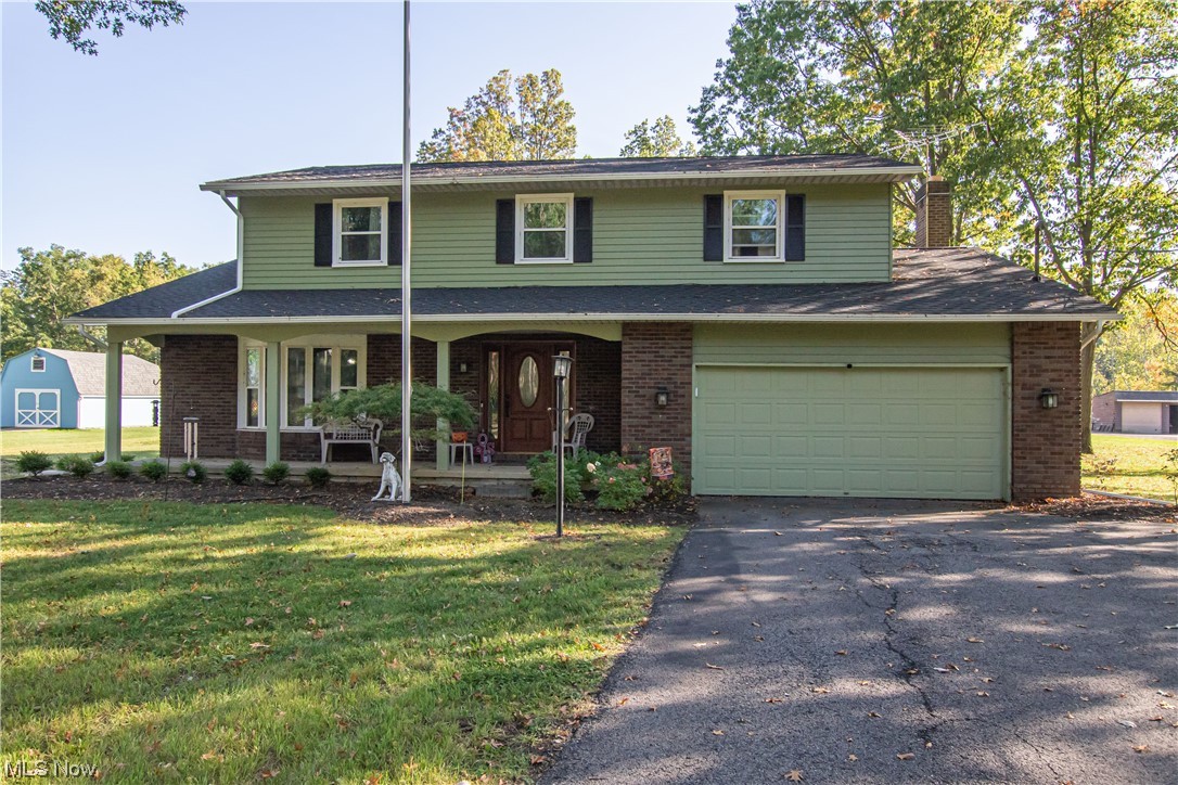 39353 Burns Road North Ridgeville, OH 44039 - Photo 1 of 35 View of front of house featuring a front yard, a garage, and a porch