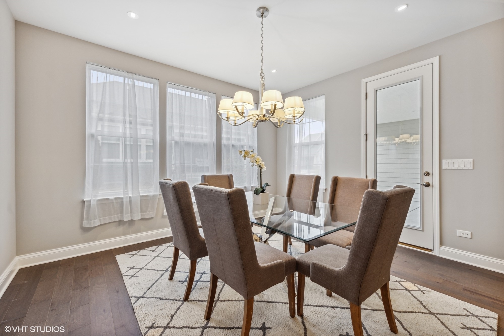 310 Arabian Circle Willowbrook, IL 60527 - Photo 15 of 36 a dining room with furniture a chandelier and wooden floor