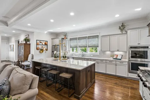 a kitchen with stainless steel appliances granite countertop a sink and cabinets