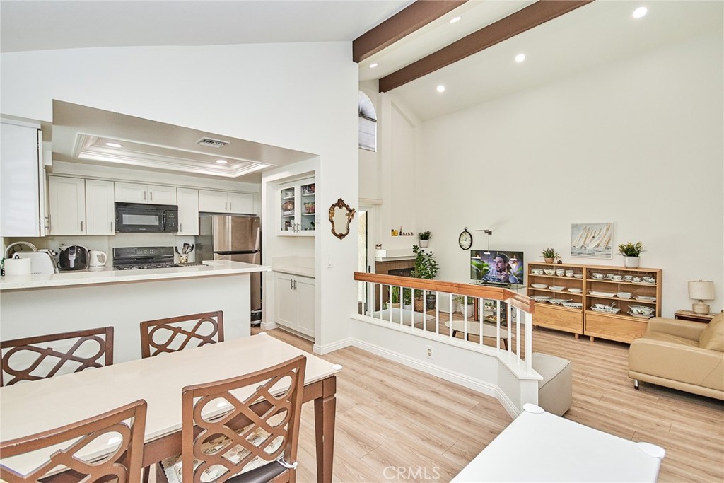 28 Wilderness Place Phillips Ranch, CA 91766 - Photo 1 of 1 a kitchen with stainless steel appliances granite countertop a refrigerator a stove and white cabinets with wooden floor