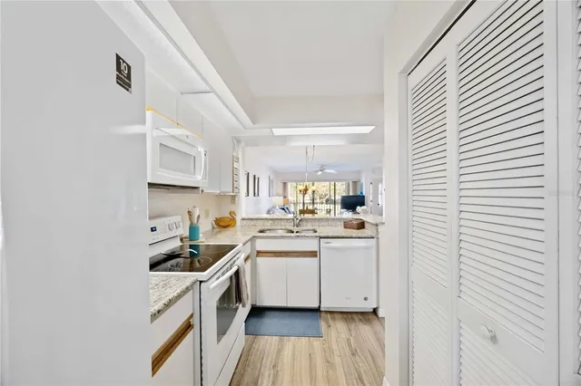 a kitchen with stainless steel appliances granite countertop a stove and a microwave