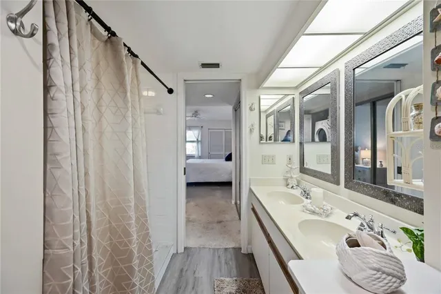 a bedroom with a bed and a lamp on dresser