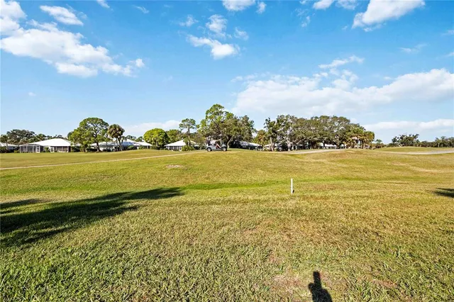 an aerial view of a house with garden space and ocean view