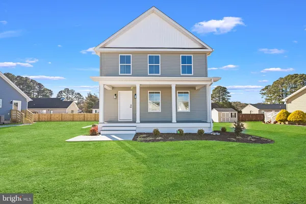 a front view of a house with a garden and plants
