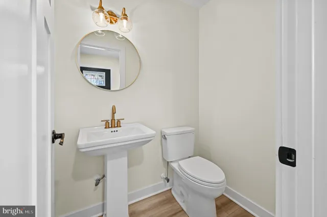 a white toilet sitting next to a bathroom sink