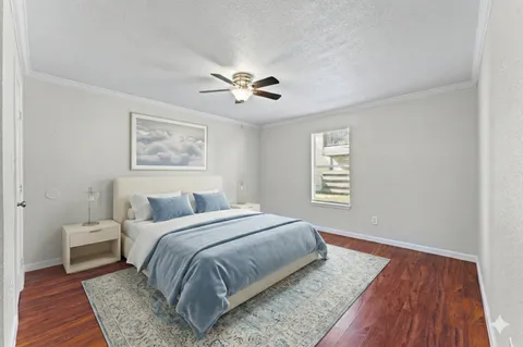 a spacious bedroom with a large bed and a chandelier