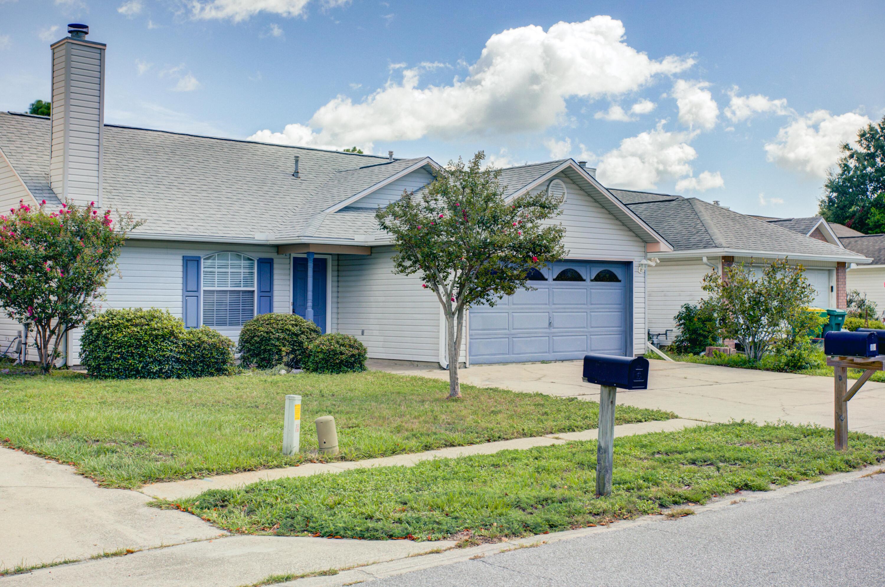 38 Ruby Circle Mary Esther, FL 32569 - Photo 1 of 16 a front view of a house with a yard and garage