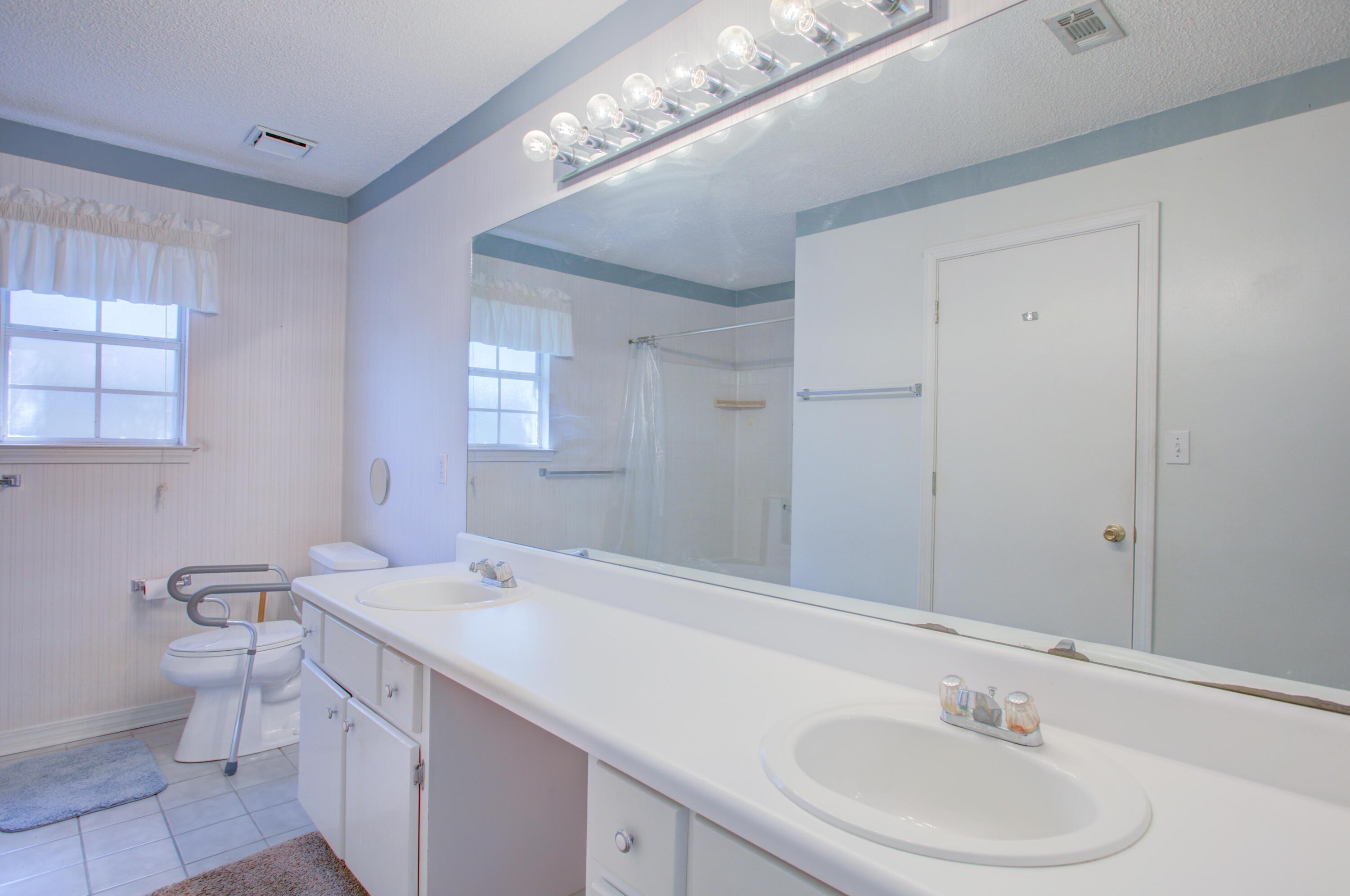 38 Ruby Circle Mary Esther, FL 32569 - Photo 11 of 16 a bathroom with a sink a toilet and a mirror