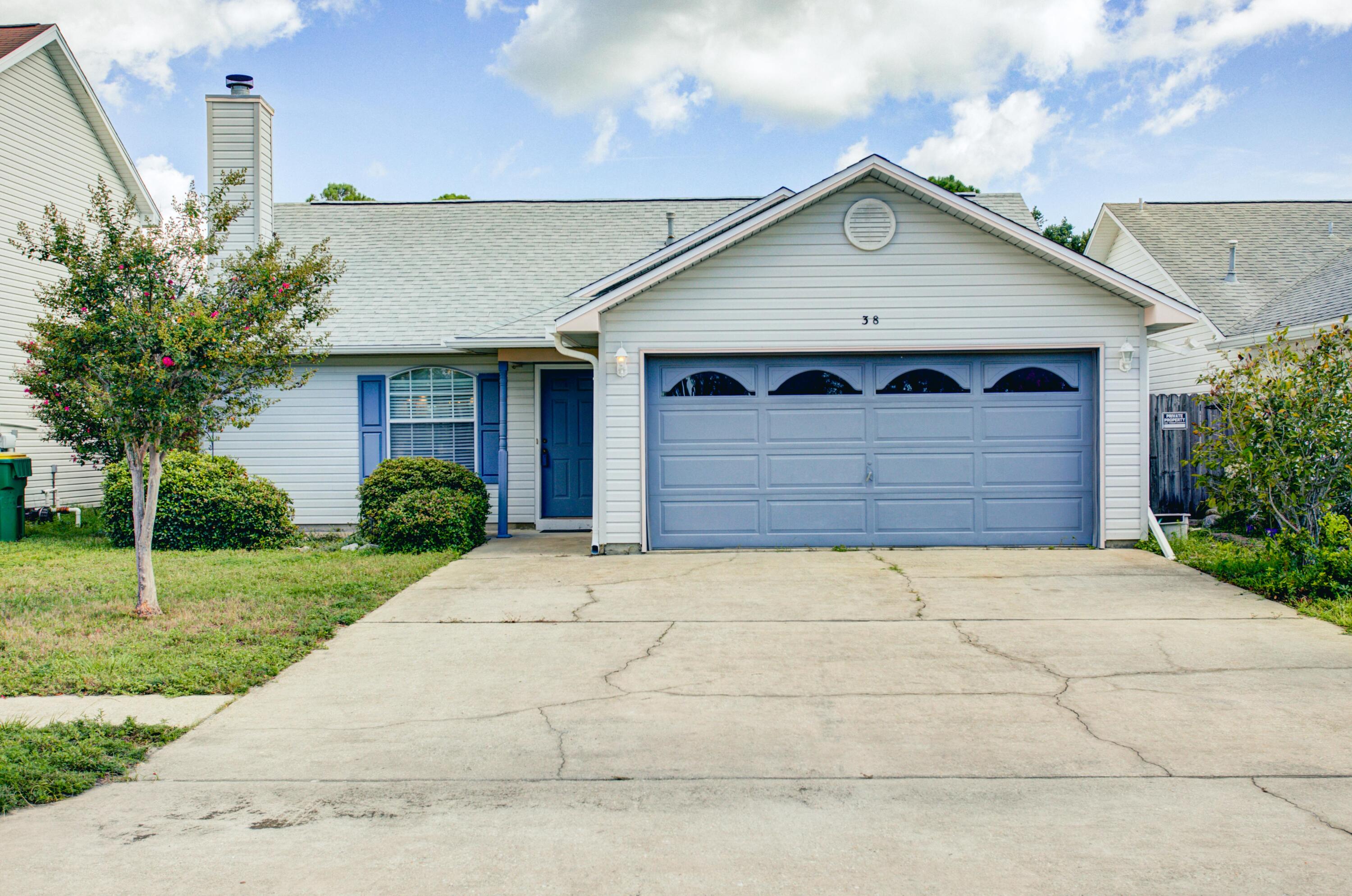 38 Ruby Circle Mary Esther, FL 32569 - Photo 2 of 16 a front view of a house with a yard and garage
