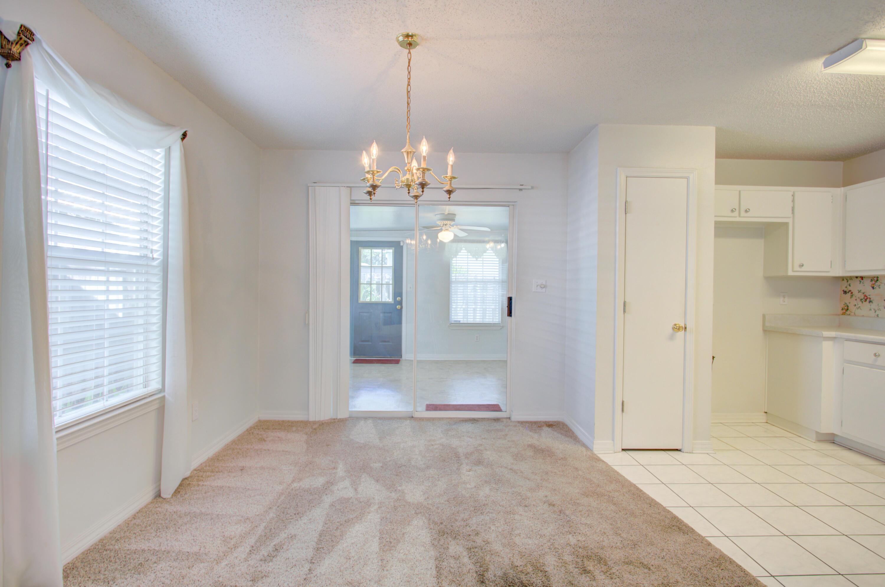 38 Ruby Circle Mary Esther, FL 32569 - Photo 7 of 16 a view of a hallway with wooden floor and a kitchen