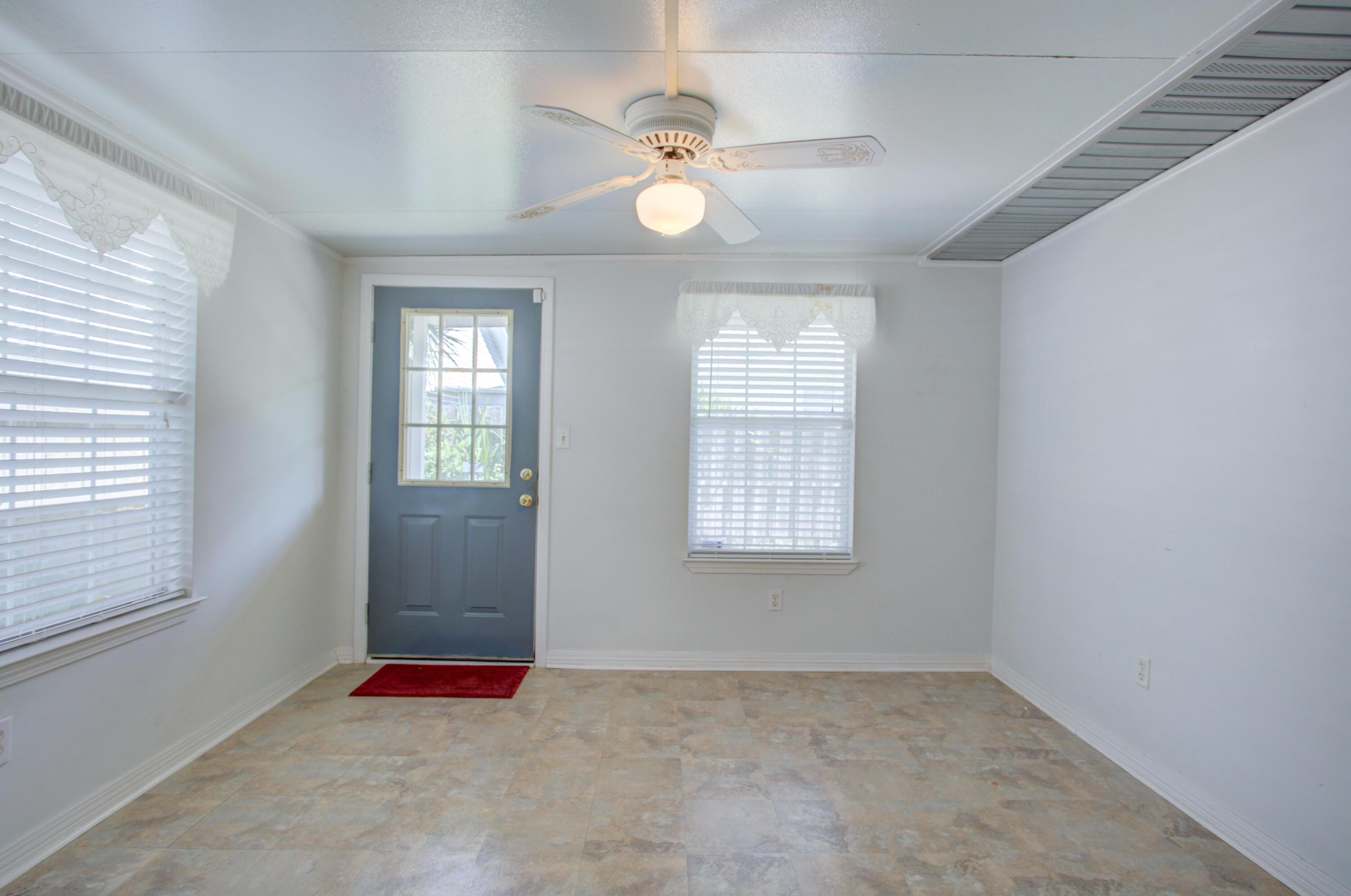 38 Ruby Circle Mary Esther, FL 32569 - Photo 8 of 16 an empty room with windows and fan