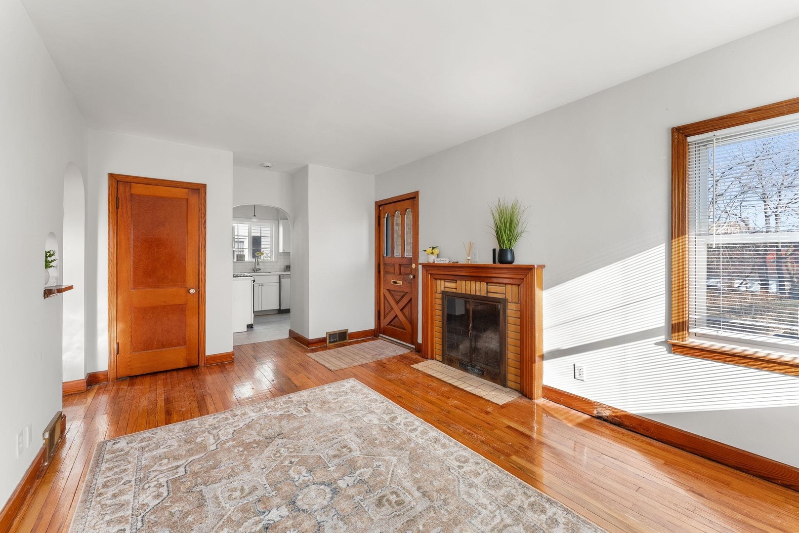 2341 33rd Street Moline, IL 61265 - Photo 4 of 12 a view of a livingroom with wooden floor and a fireplace