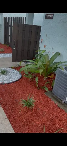 a view of backyard with swimming pool and seating space