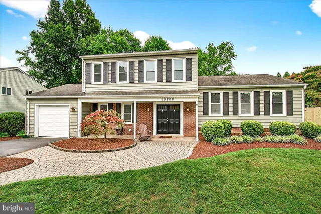 a front view of a house with a yard and porch