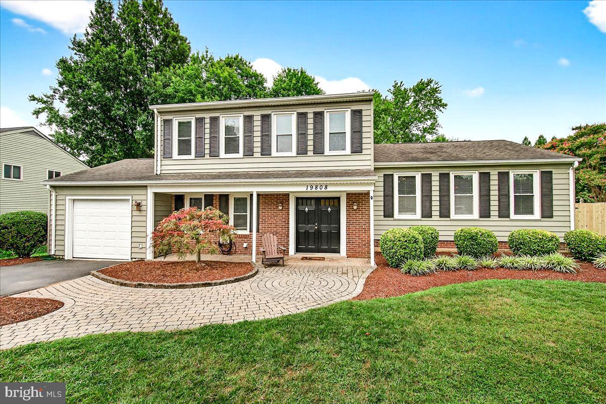 a front view of a house with a yard and porch