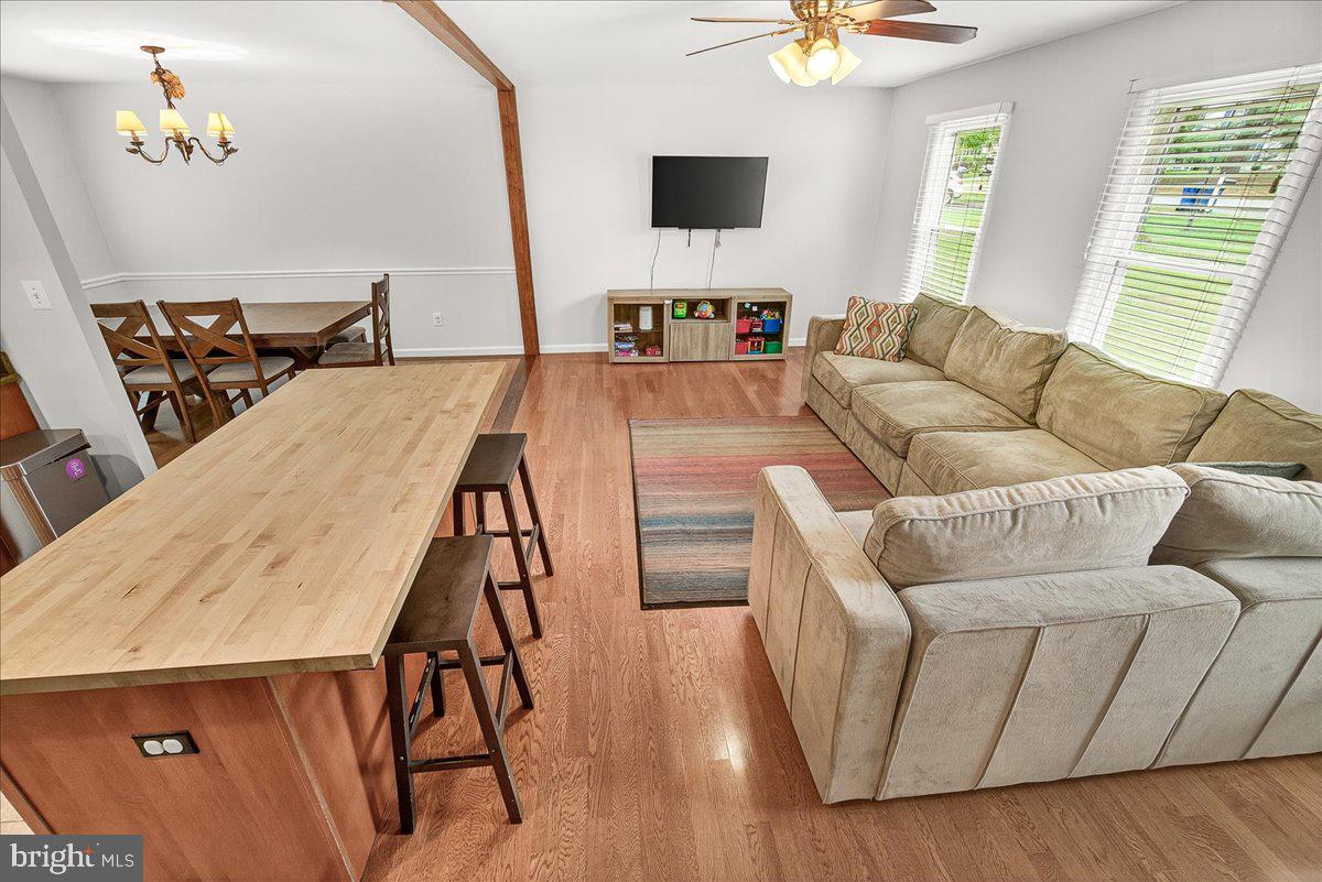 19808 Westerly Avenue Poolesville, MD 20837 - Photo 16 of 64 a living room with furniture and a flat screen tv