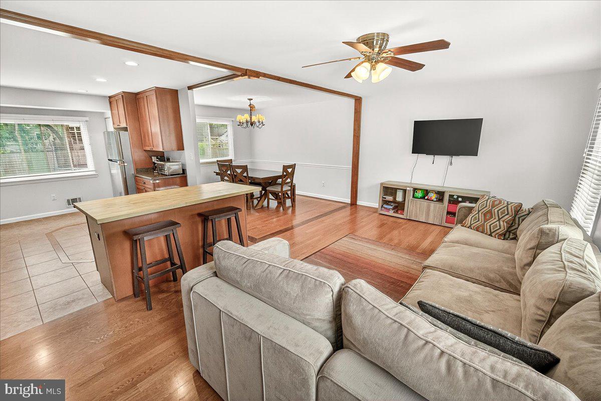 19808 Westerly Avenue Poolesville, MD 20837 - Photo 17 of 64 a living room with furniture a flat screen tv and a large window