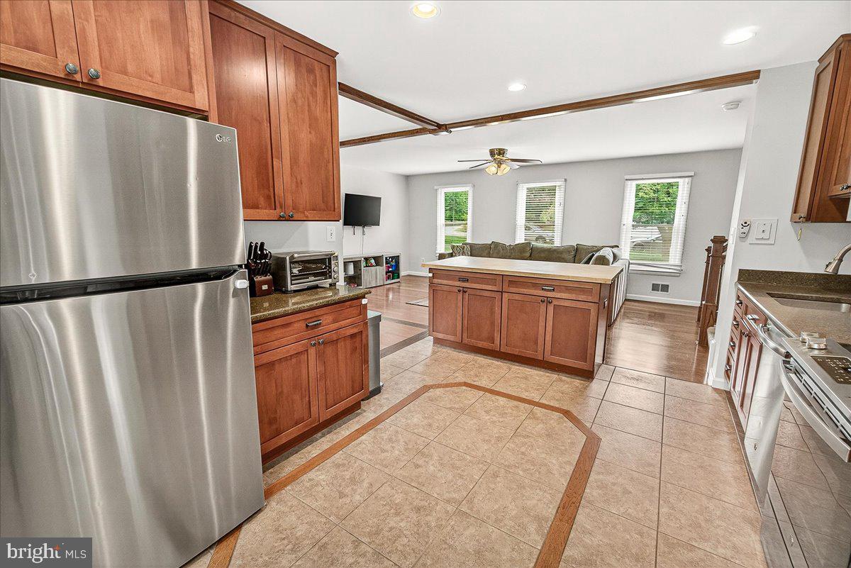 19808 Westerly Avenue Poolesville, MD 20837 - Photo 18 of 64 a kitchen with stainless steel appliances granite countertop a refrigerator a stove a sink and a microwave