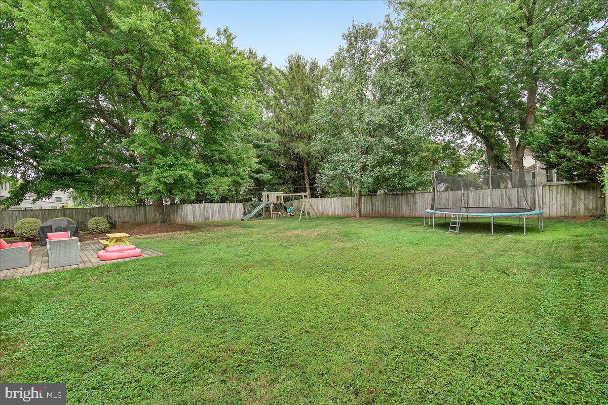 19808 Westerly Avenue Poolesville, MD 20837 - Photo 2 of 64 a view of a backyard with a garden and trees